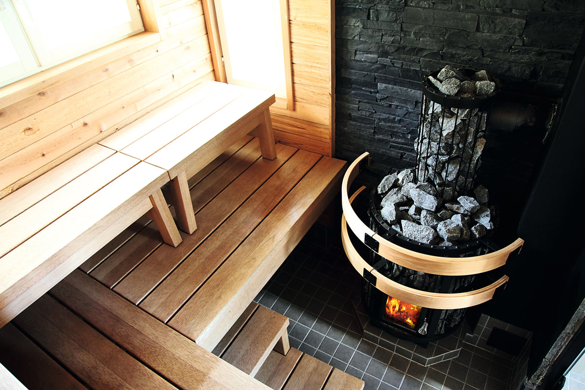 Harvia Legend 150 wood-burning sauna heater with chimney in a sauna