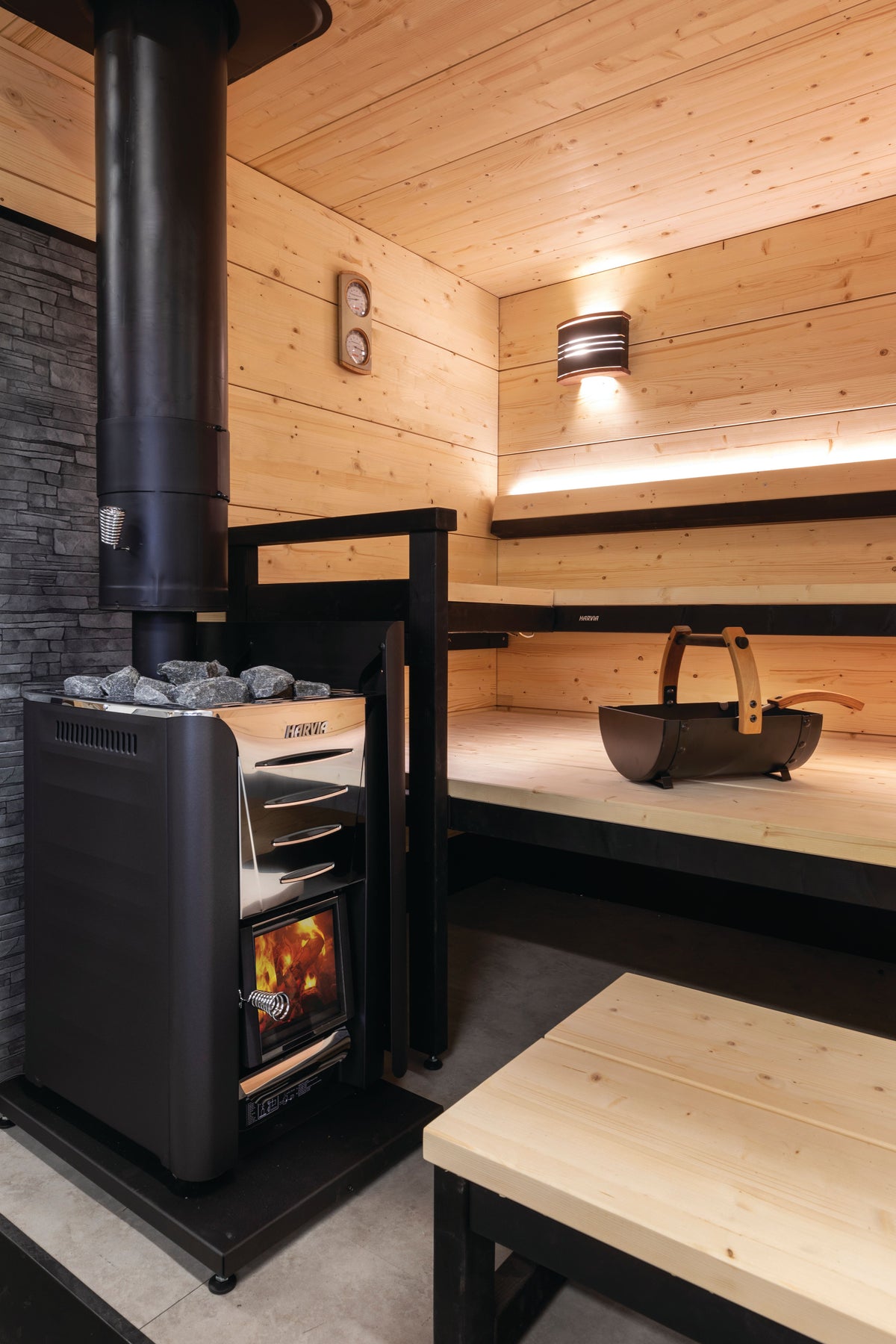 Harvia Pro 20 stove with black chimney in a sauna